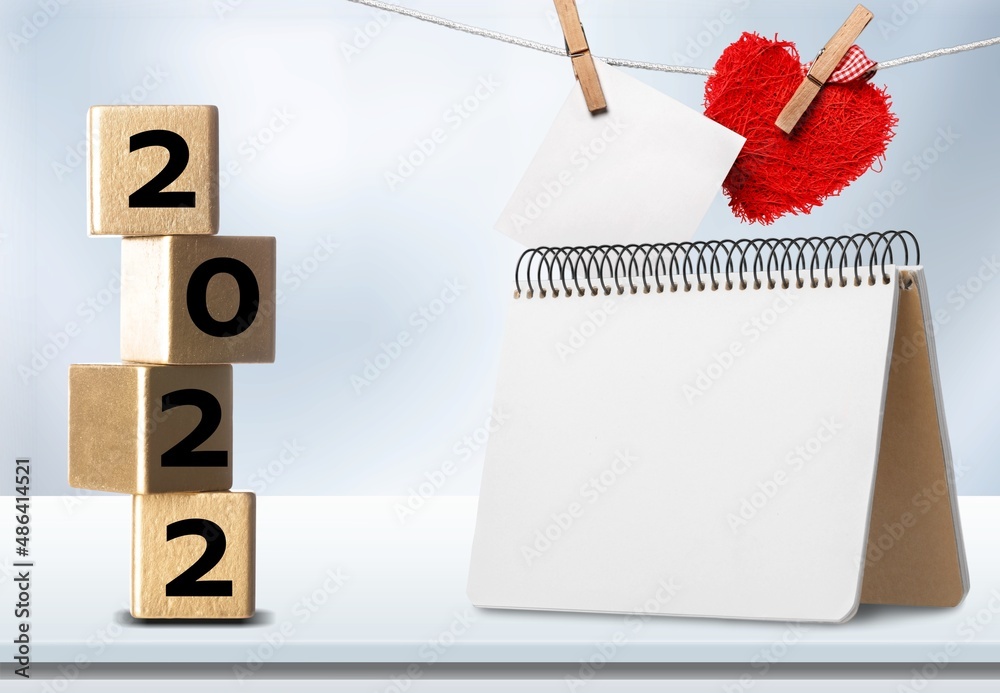 2022 cubes with red heart shape and empty notebook on table, Love and Happy Valentine day concept