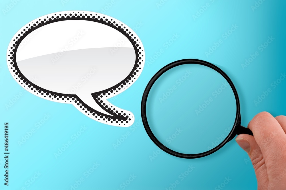 A blank speech bubble and hand holding a magnifying glass on a background.