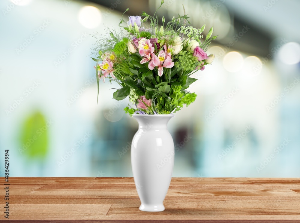 Autumn still life with garden flowers. Beautiful bouquet in a vase on wooden table.