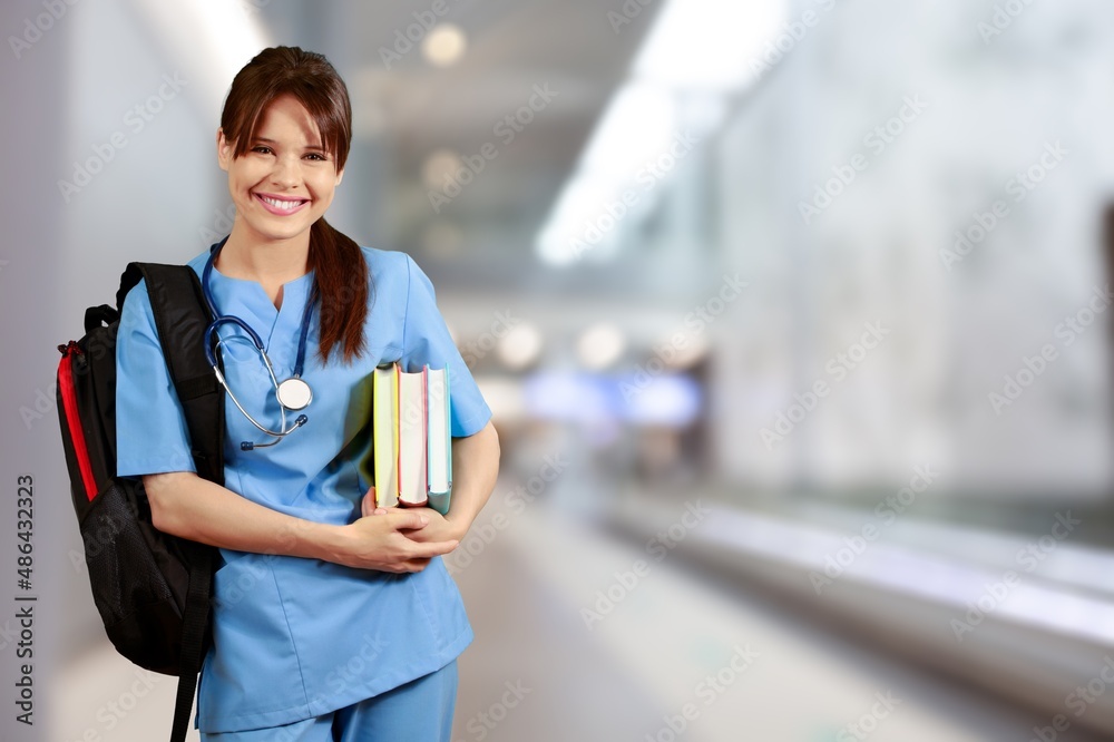 Beautiful young doctor, with a book for records. Medical student general practitioner.