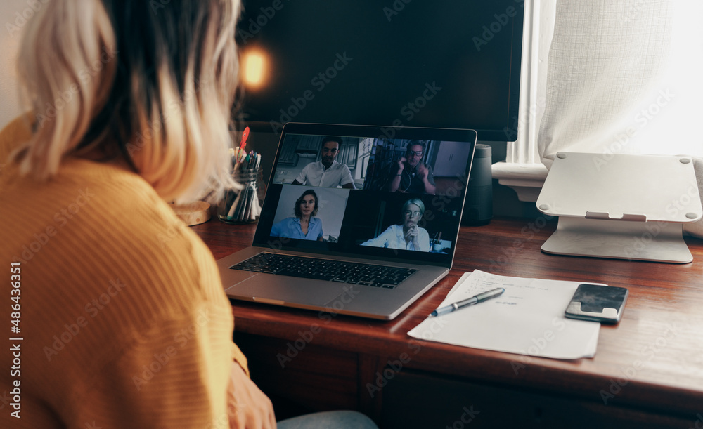 Businesswoman attending a virtual meeting while working from home