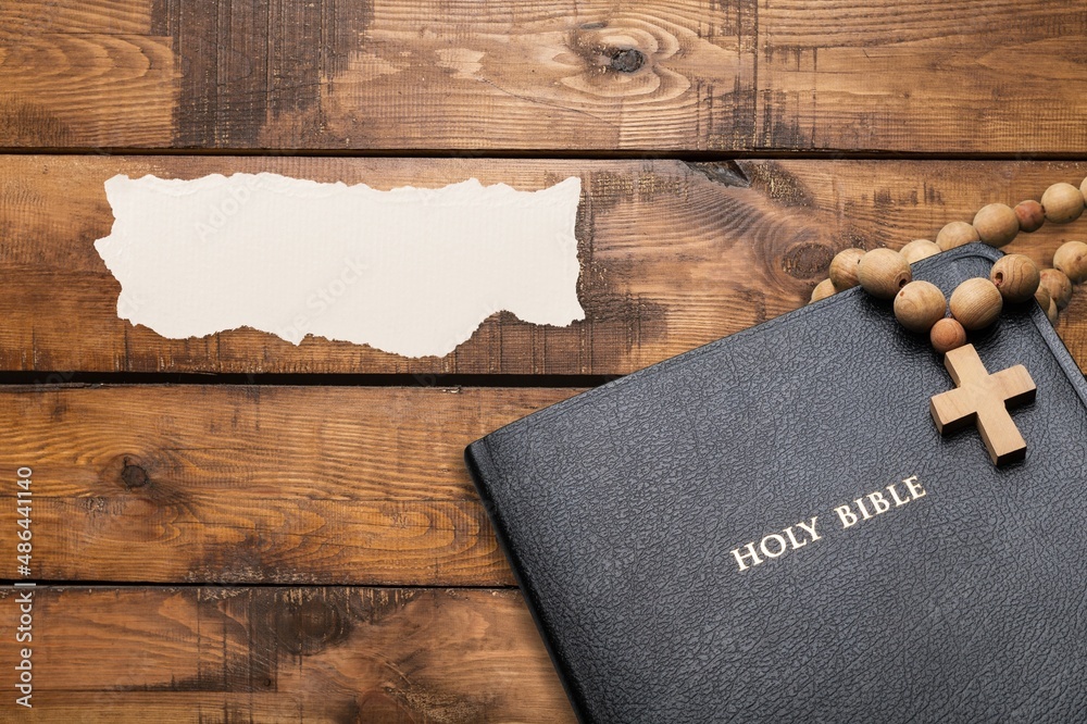 Concept of message on wooden background with closed Bible. God Jesus Christ