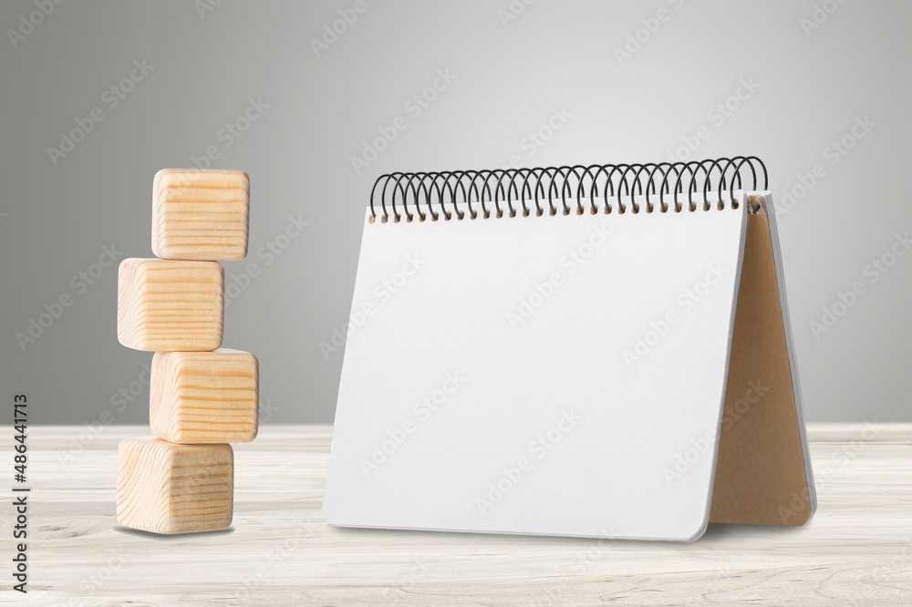 2022 mockup notepad and cubes wooden on table background, plans for New Year 2022