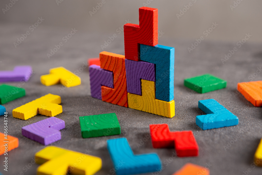 Creative idea solution - business concept, jigsaw puzzle on the grey background. Leadership and team