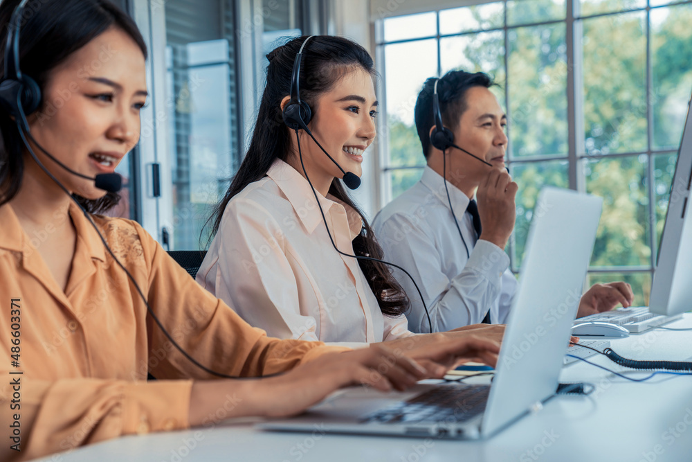 Business people wearing headset working actively in office . Call center, telemarketing, customer su