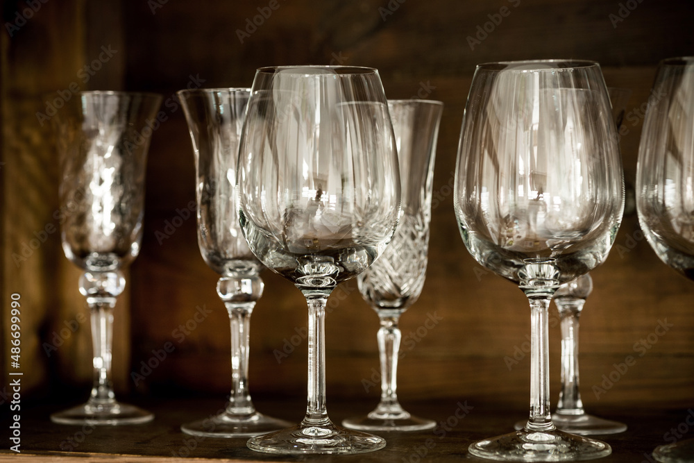 glasses on the shelf of an old cabinet