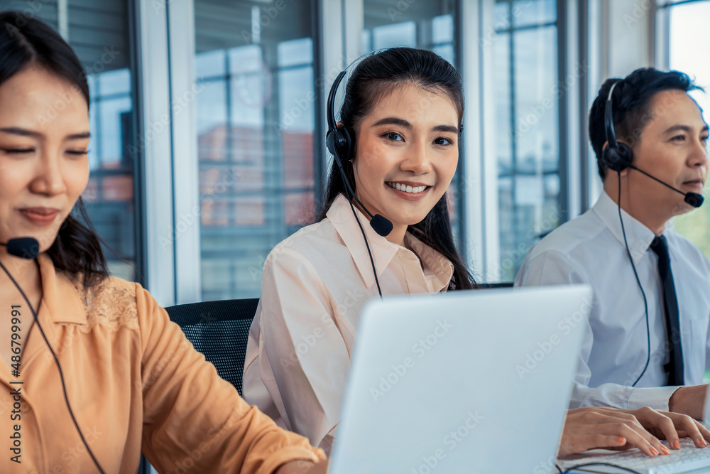 Business people wearing headset working actively in office . Call center, telemarketing, customer su