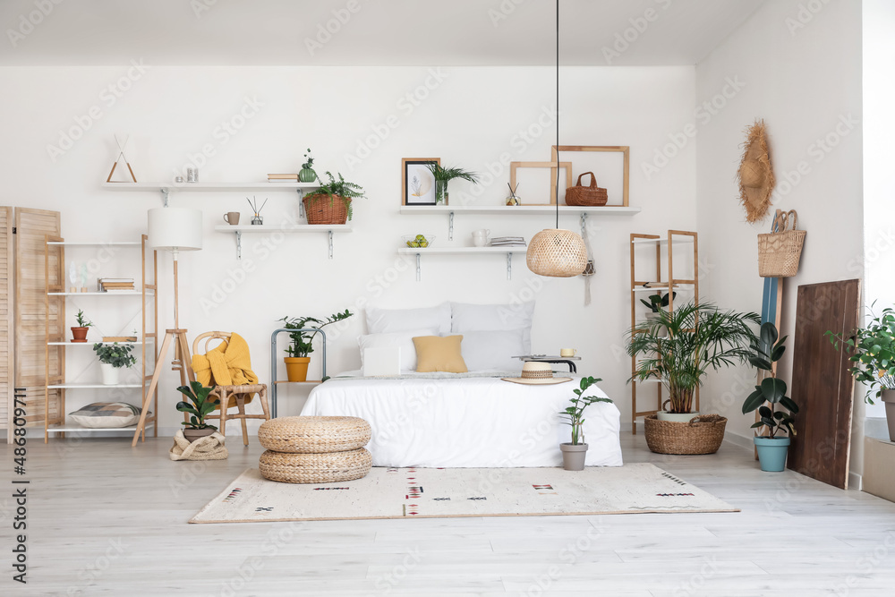 Stylish interior of modern bedroom with houseplants