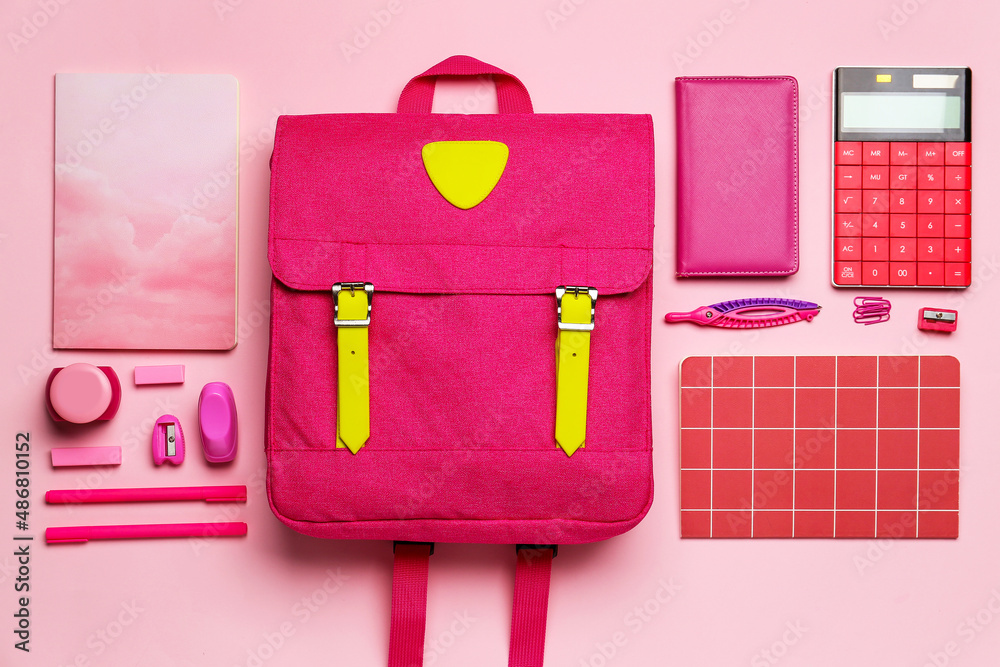 Set of stationery and stylish backpack on pink background