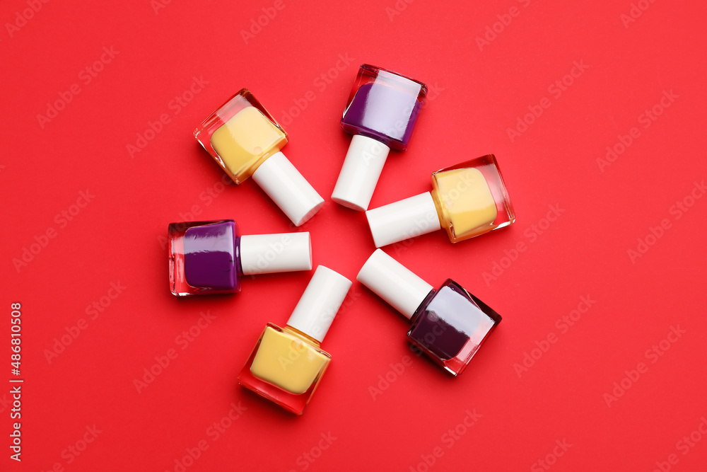 Set of nail polish bottles on color background