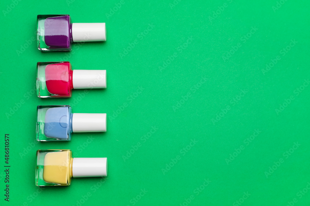 Set of nail polish bottles on color background