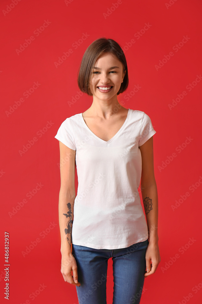 Beautiful young woman in stylish t-shirt on color background