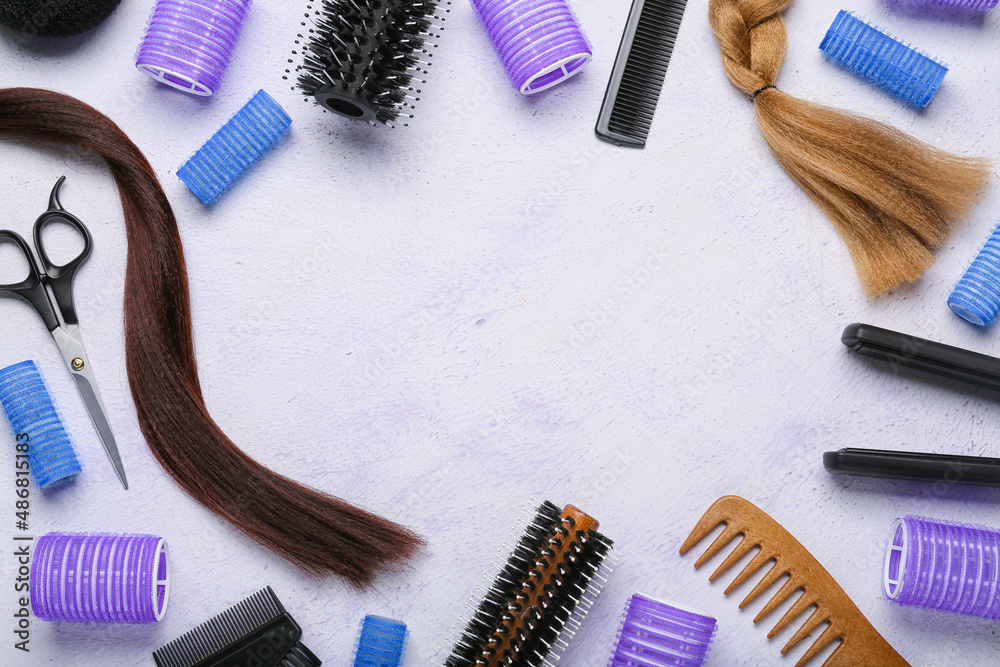 Frame made of hairdressers tools with curlers and strands on white background