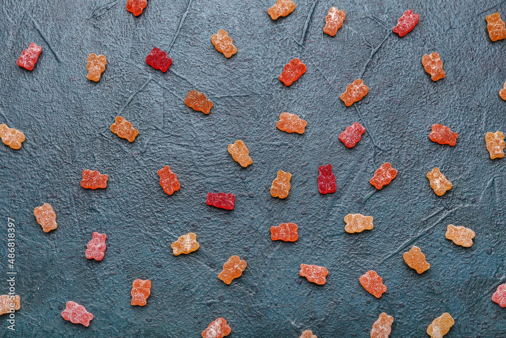 Different tasty jelly bears on dark background