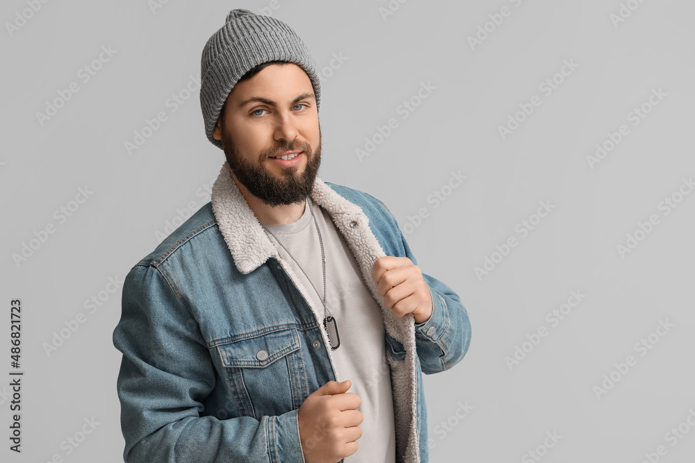 Stylish bearded man on grey background