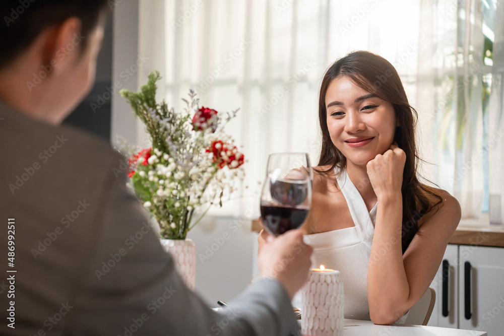 Asian young couple having dinner to celebrate valentines day together. 