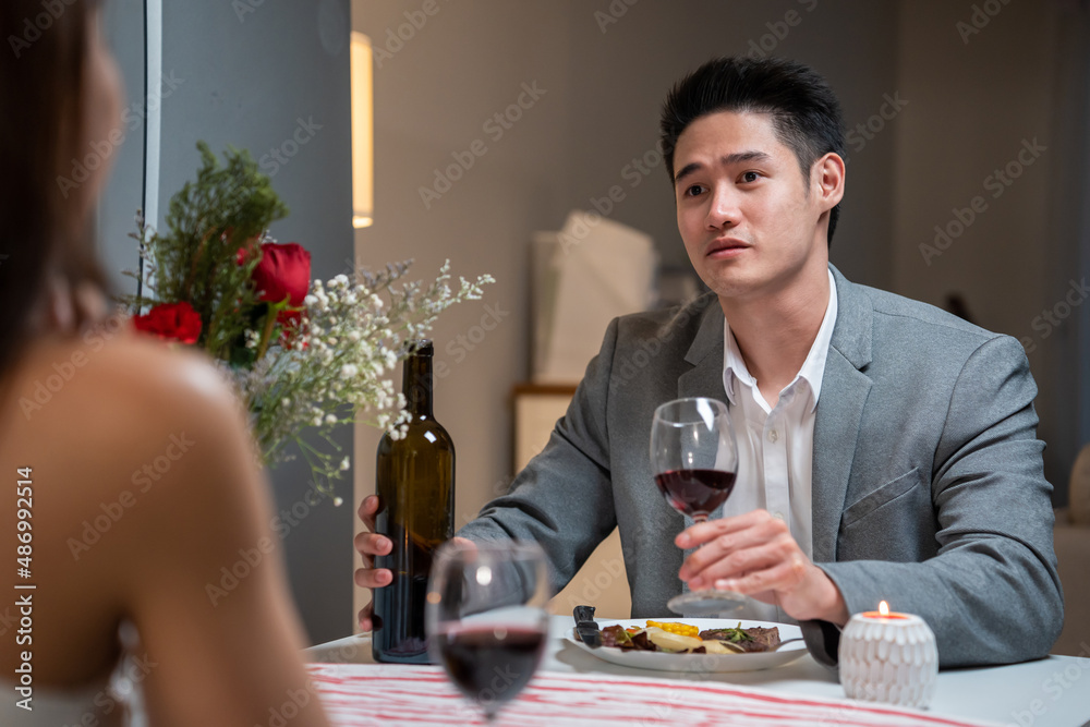 Asian young couple having dinner to celebrate valentines day together. 