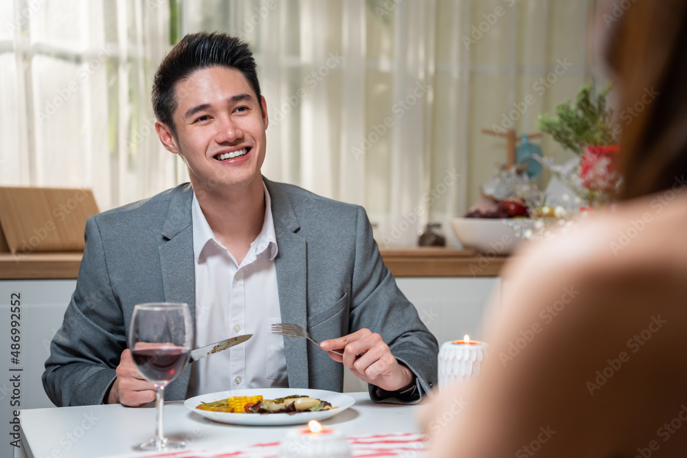 Asian young couple having dinner to celebrate valentines day together.