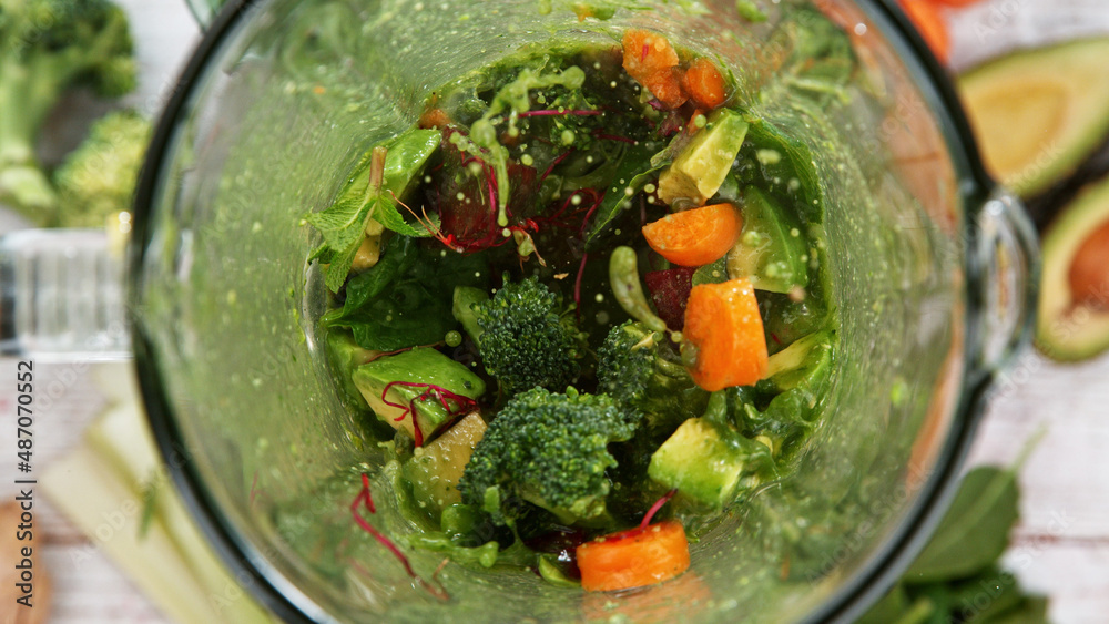 Mixing pieces of Vegetables in blender, top view.