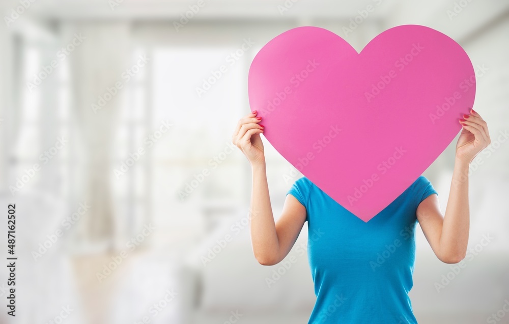 Charming lady with heart postcard on colored background