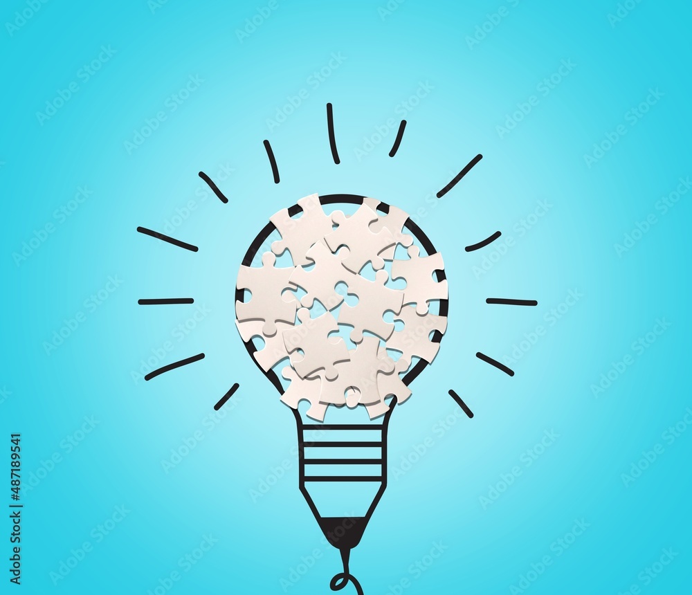 Light bulb from puzzles on background. Inspiration and creative idea concept.