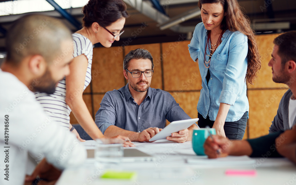 Making tomorrows success today. Shot of a group of coworkers having a meeting in an open plan office