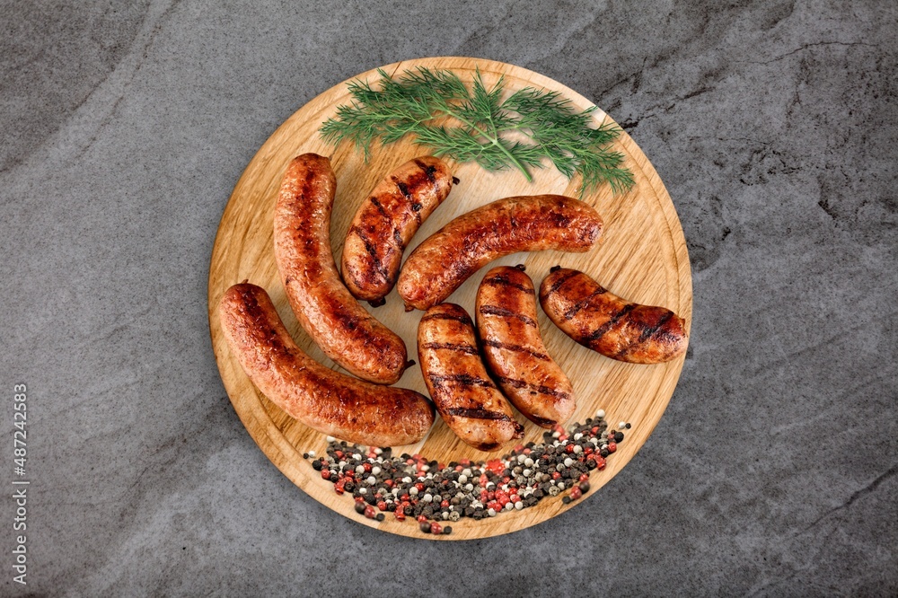 Roasted tasty pork meat sausages on the desk