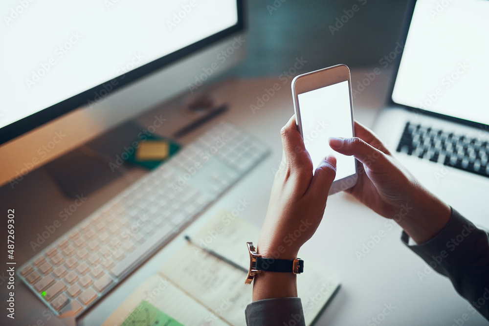 Important texts to the boss. Cropped shot of an unrecognizable woman using a cellphone in the office