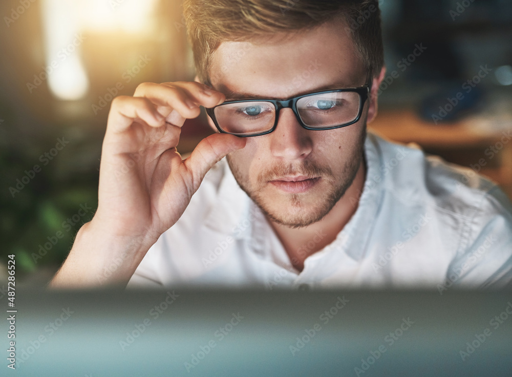 Am I seeing this right. Shot of a young designer adjusting his glasses as he looks at his computer s