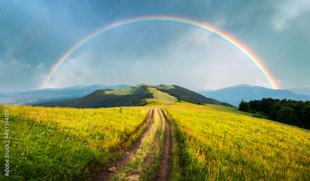 夏日群山中令人惊叹的景象。美妙的傍晚阳光下，郁郁葱葱的草地。乡村摇滚