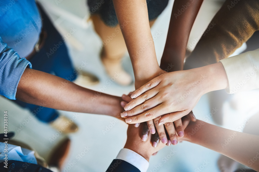 Together we can do great things. Cropped shot of a group of businesspeople piling their hands on top