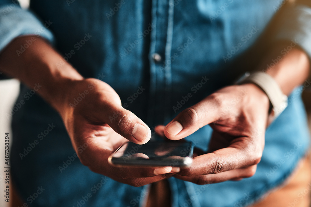 My customers can text me too. Cropped shot of an unrecognizable businessman standing alone in his ho