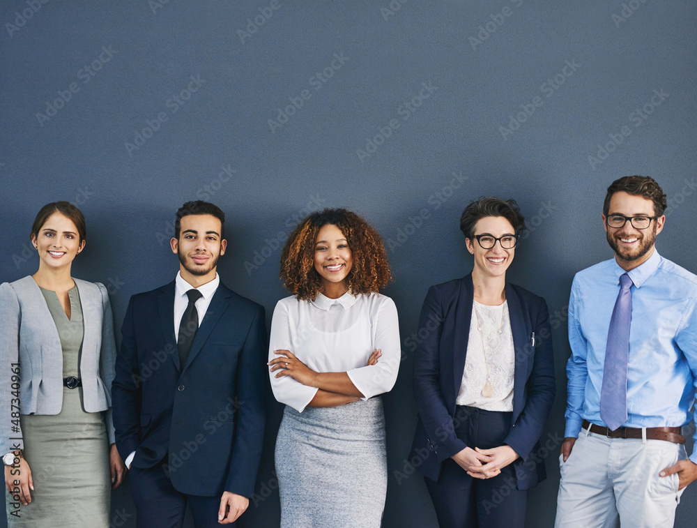 Weve each got our role to play. Studio shot of a group of businesspeople standing in line against a 