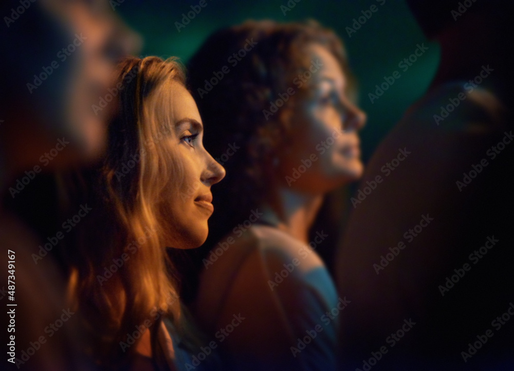 Young woman looking at the stage at a concert. This concert was created for the sole purpose of this