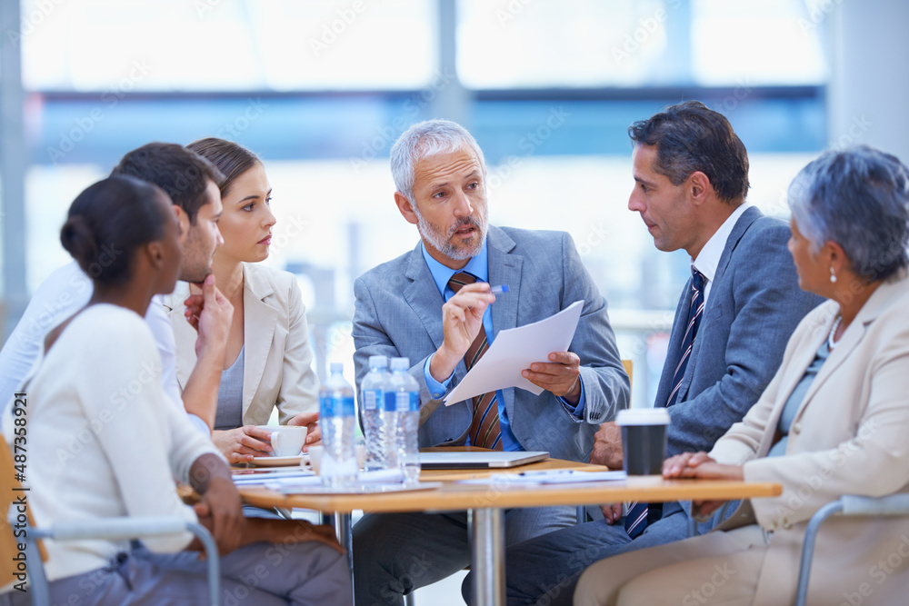 Sitting down to strategize. A cropped shot of a diverse group of businesspeople having a meeting.