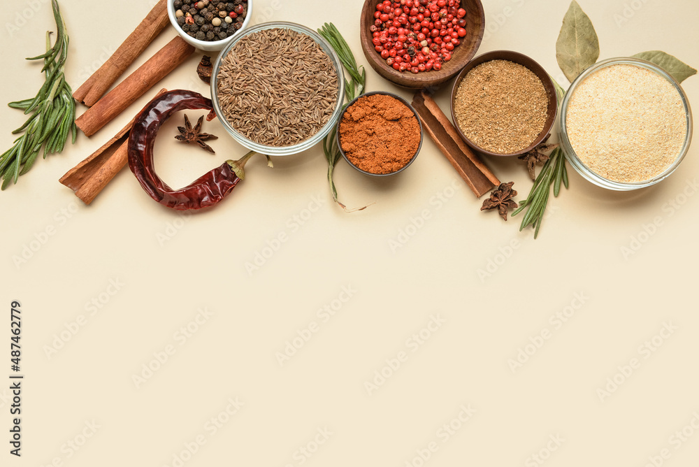 Composition with bowls of aromatic spices on color background