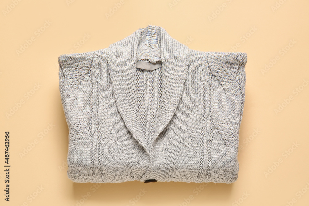 Stylish sweater on color background