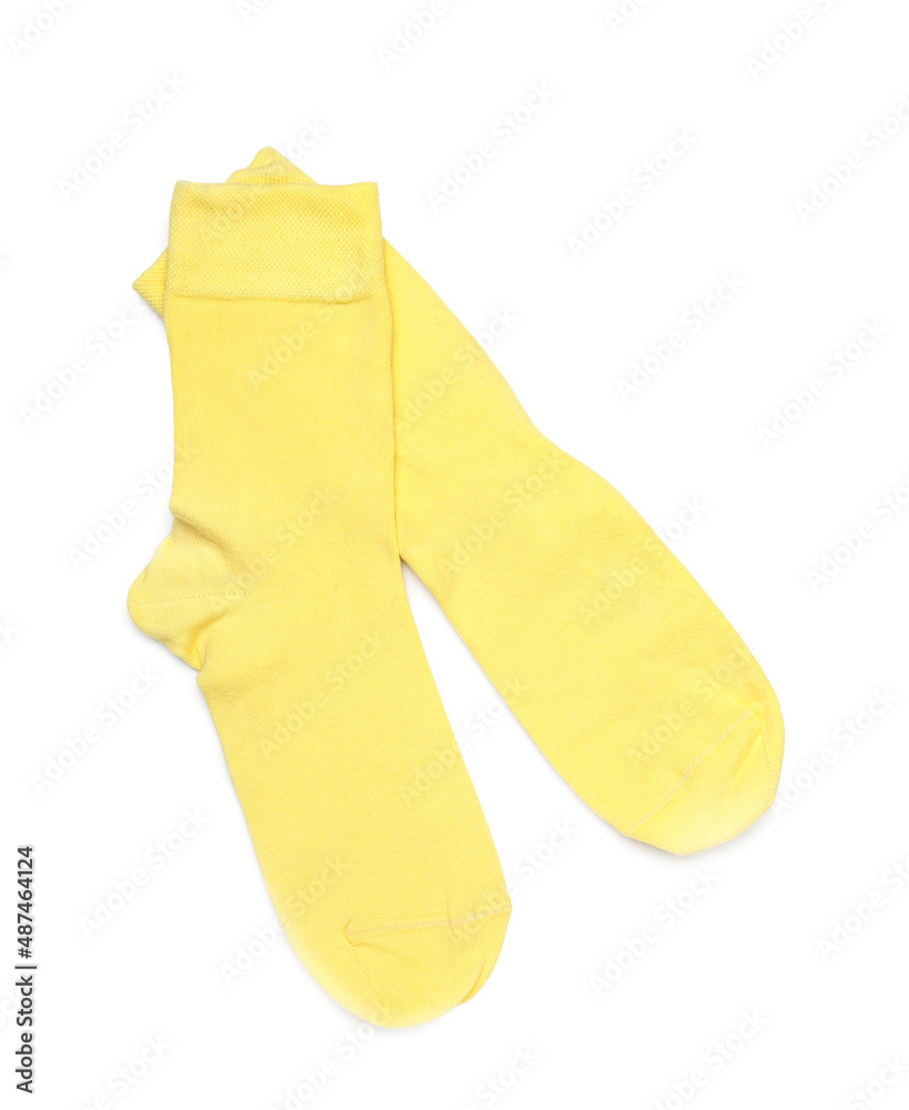 Pair of yellow socks on white background