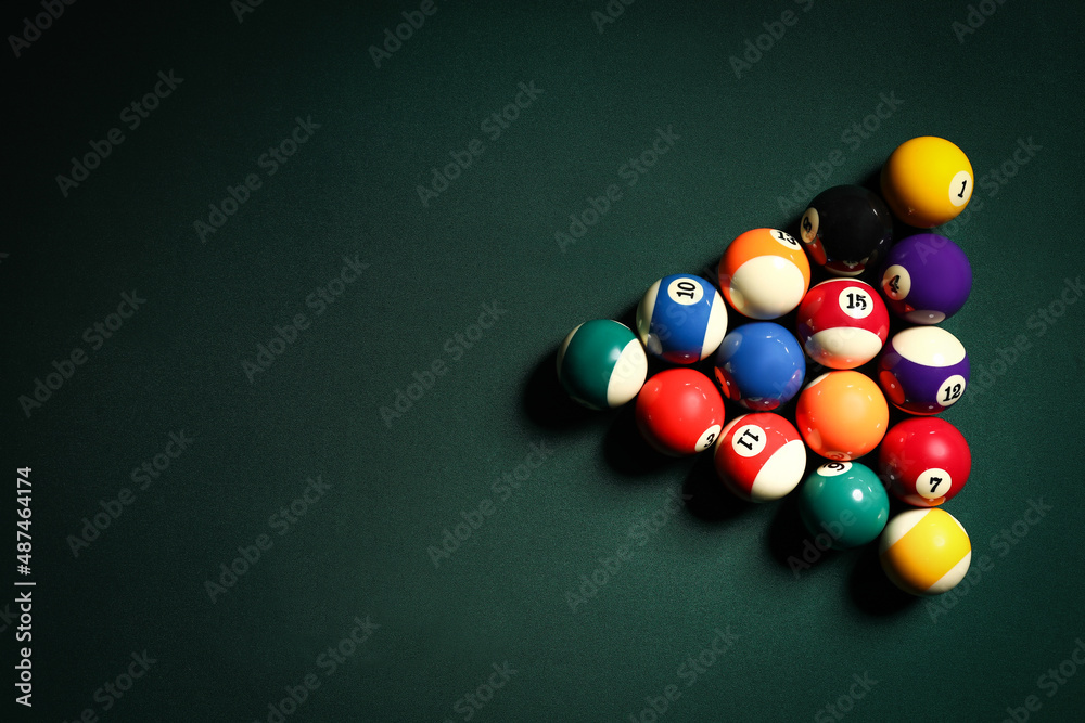 Different billiard balls on table