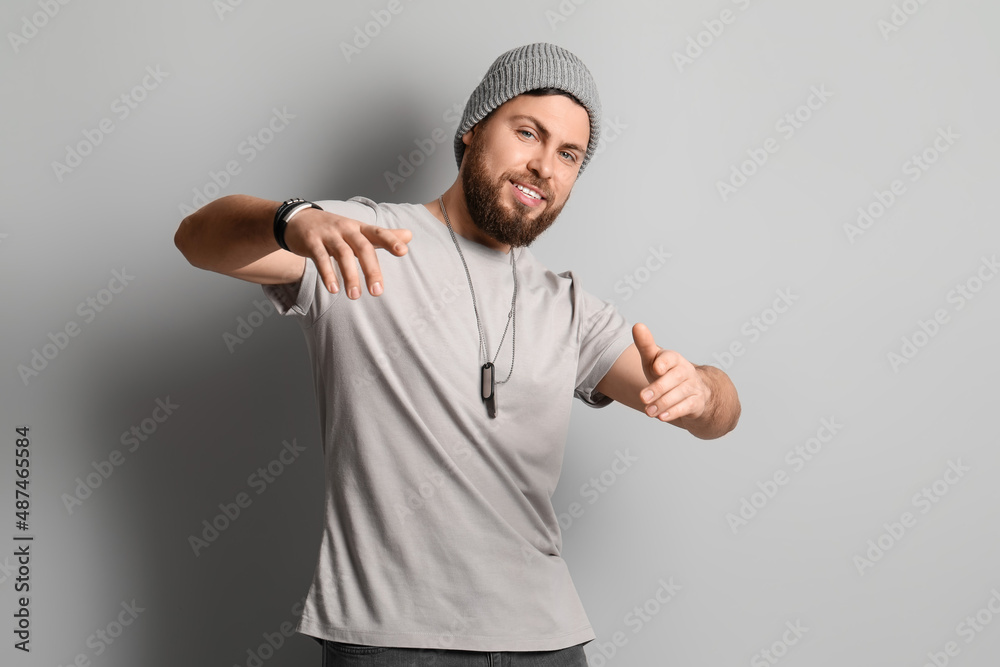 Stylish cool bearded man on grey background