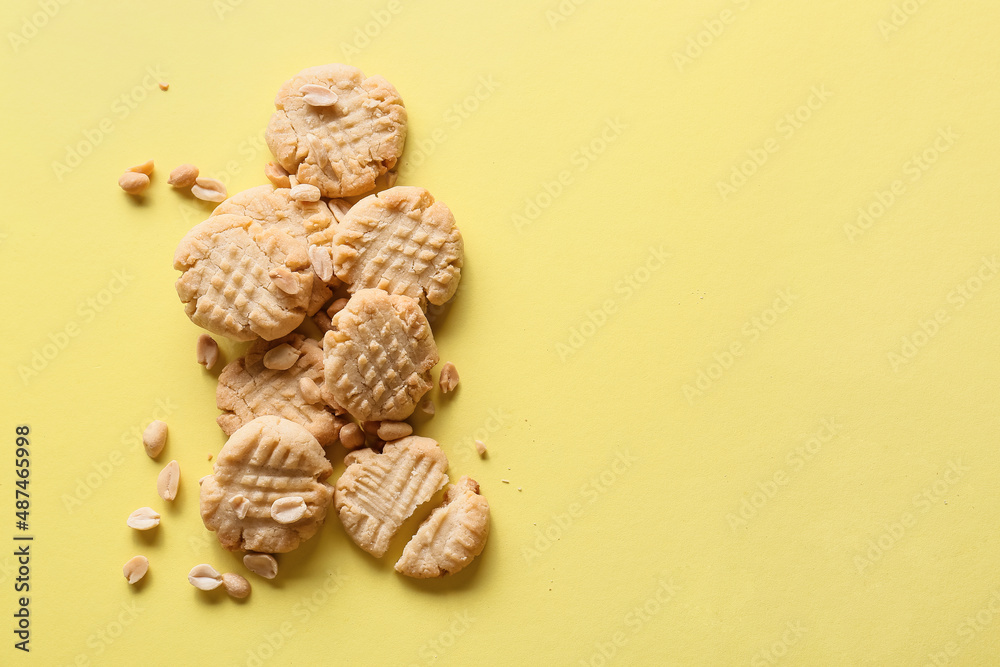 Tasty peanut cookies on yellow background