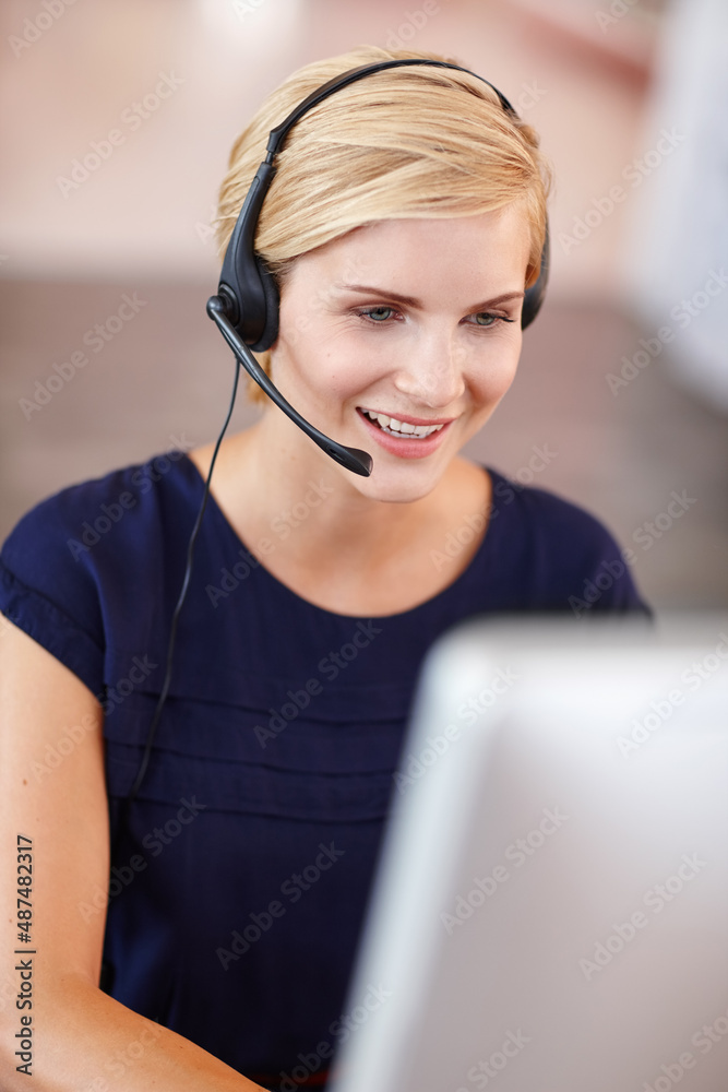 Assisting a customer. Cropped shot an attractive young businesswoman working on her laptop.