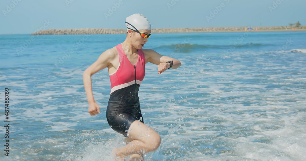 woman training triathlon at beach