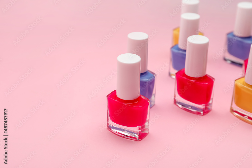 Set of nail polish bottles on color background