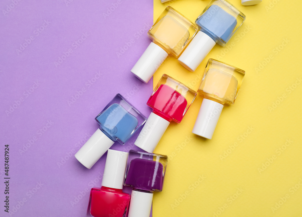 Set of nail polish bottles on color background