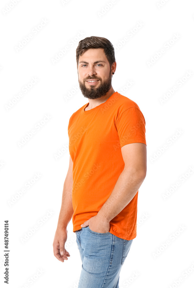 Handsome man in bright orange t-shirt on white background