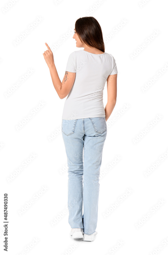 Young woman in blank t-shirt showing something on white background, back view