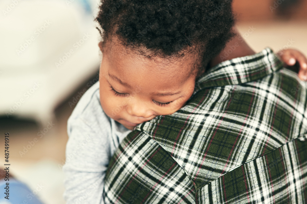 Sleep solves everything. Shot of an adorable baby boy falling asleep on his mothers shoulders.