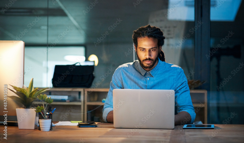 To stay productive you need to stay persistent. Cropped shot of a young designer working late on a l