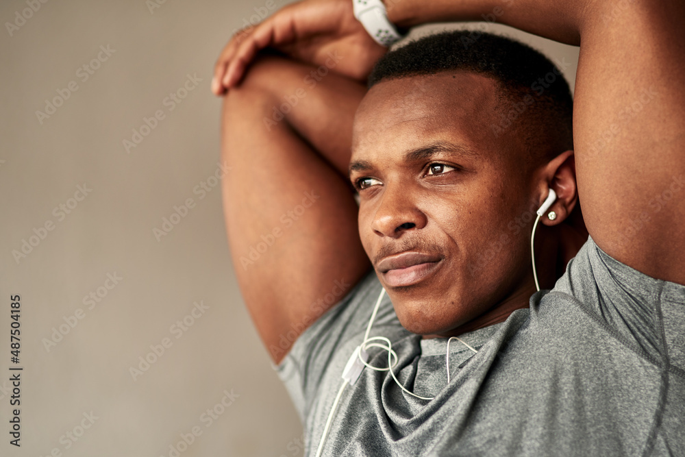 Do what it takes to live a healthy and happy life. Cropped shot of a sporty young man stretching at 